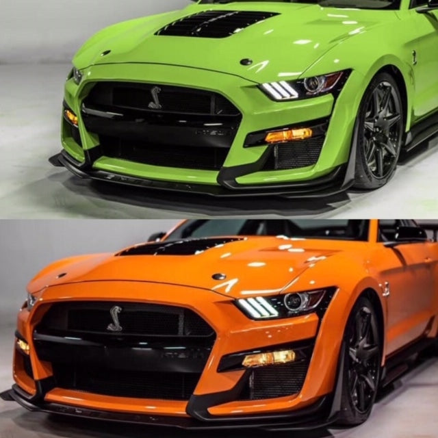 The image shows two Ford Mustang models, one with the standard front bumper in green, and the other with the GT500 style front bumper in orange.