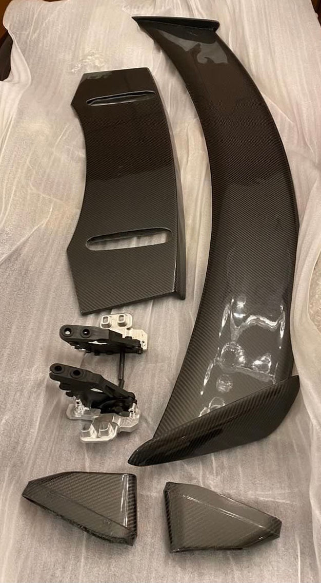 active spoiler for jaguar f type with parts laid out on a white package wrap