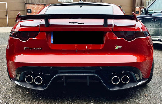 The image shows a red Jaguar F Type V8 with the carbon fibre diffuser installed at the rear of the vehicle.