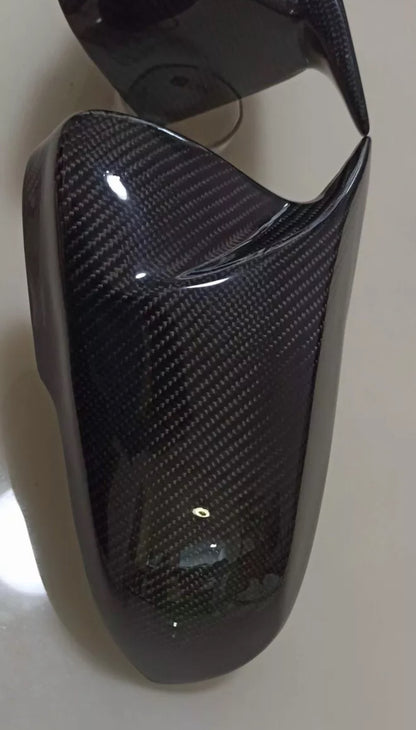 Carbon fiber-textured mirror cover on a white background