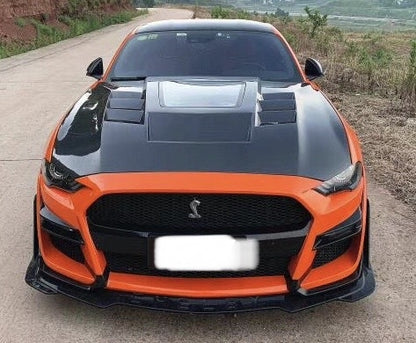 A Ford Mustang with a black carbon fibre vented bonnet hood.