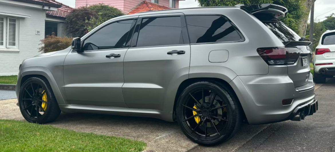silver jeep grand cherokee SRT8 body kit upgrade side view showcasing the rear diffuser and side skirts