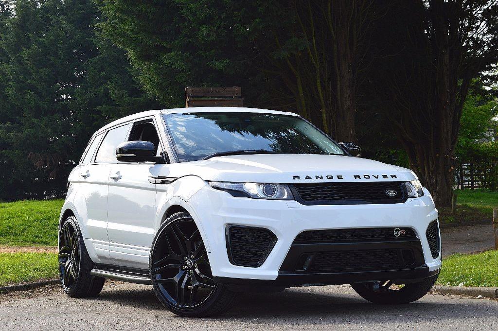 A white Range Rover Evoque with a white body kit, including front bumper and grille, parked outdoors.